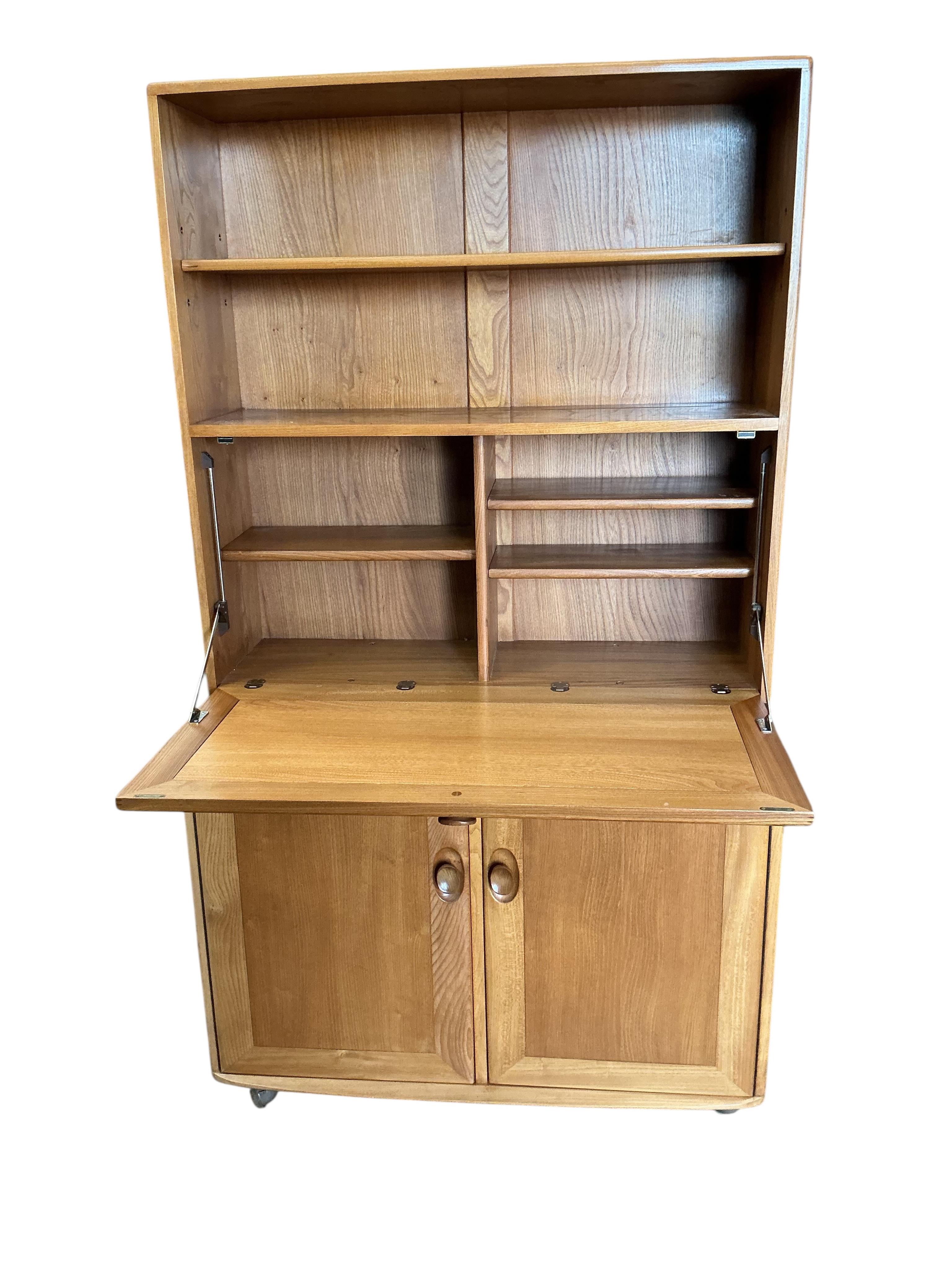 An Ercol Windsor light elm writing cabinet, width 91cm, depth 45cm, height 163cm